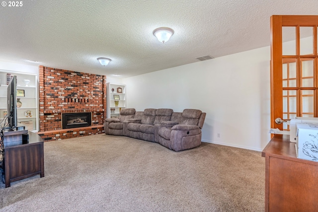 carpeted living area featuring a fireplace, a textured ceiling, and visible vents