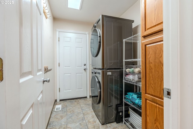 laundry room featuring visible vents and stacked washer and clothes dryer