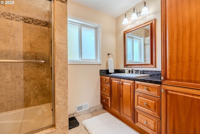 full bath featuring visible vents, vanity, baseboards, tile patterned floors, and a shower stall
