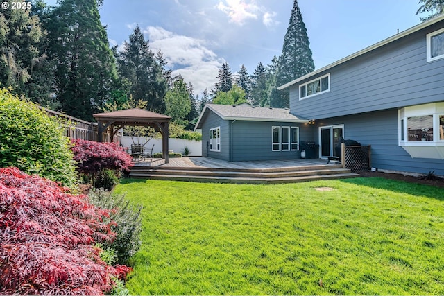 back of property featuring a gazebo, fence, a yard, and a deck