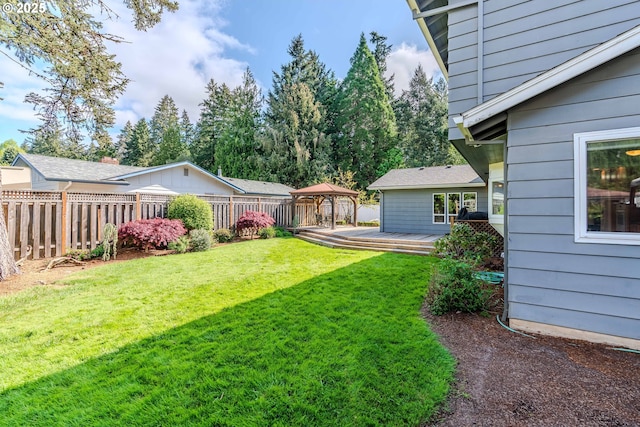 view of yard featuring a gazebo, fence, and a deck