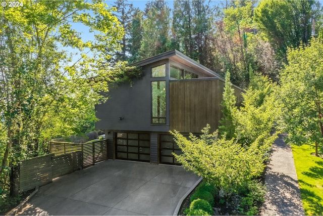 4255 SW Bertha Ave, Portland, OR 97239 - view of outdoor structure with a garage and concrete driveway