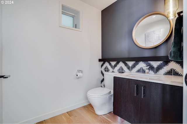 4255 SW Bertha Ave, Portland, OR 97239 - half bath featuring wood finished floors, vanity, baseboards, and toilet