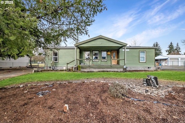 manufactured / mobile home featuring a porch, crawl space, a front lawn, and fence