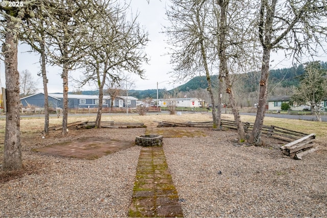 view of yard with an outdoor fire pit