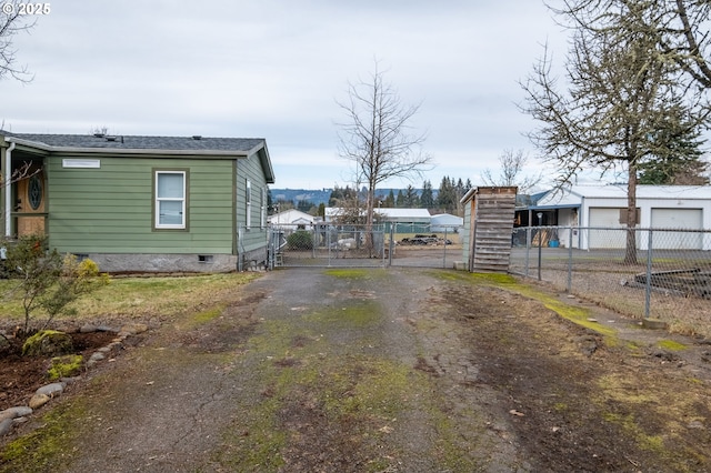 view of road featuring driveway, a gate, and a gated entry