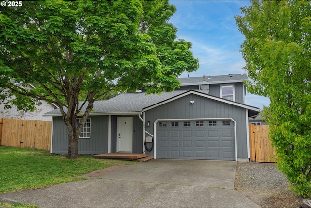 view of front of home featuring driveway, a shingled roof, fence, a front lawn, and a garage