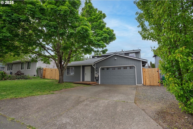 ranch-style house featuring concrete driveway, a gate, a front yard, fence, and a garage