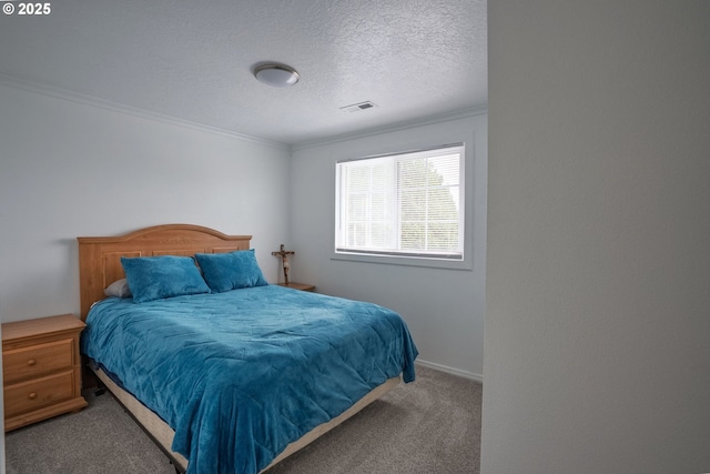 bedroom featuring carpet flooring, baseboards, visible vents, a textured ceiling, and crown molding