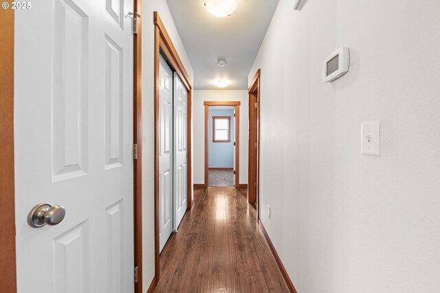 corridor with dark wood-type flooring