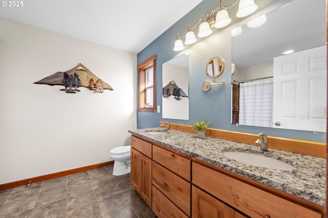 bathroom featuring toilet, vanity, and curtained shower