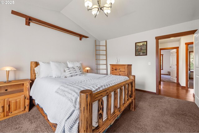 bedroom with dark carpet, lofted ceiling, and a chandelier