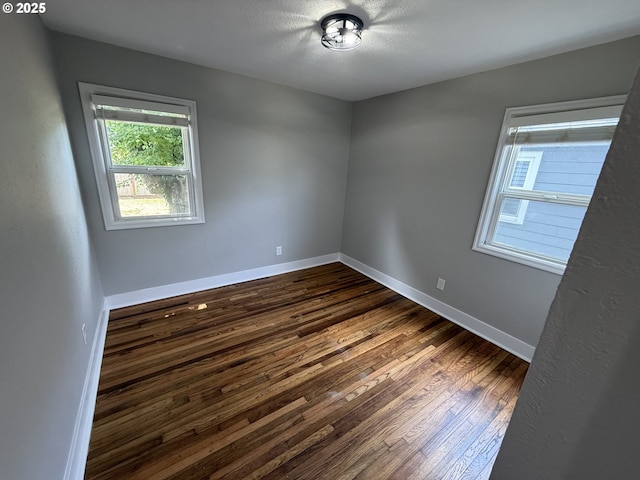 9036 SE Washington St, Portland, OR 97216 - unfurnished room with dark wood finished floors and a textured ceiling