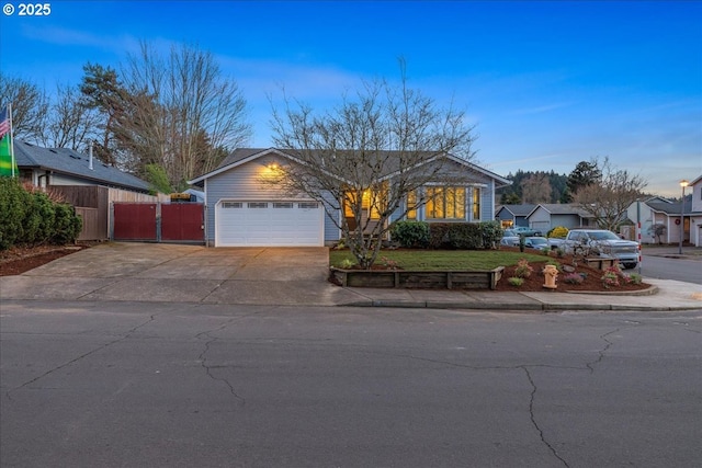 ranch-style house featuring driveway, an attached garage, fence, and a front lawn