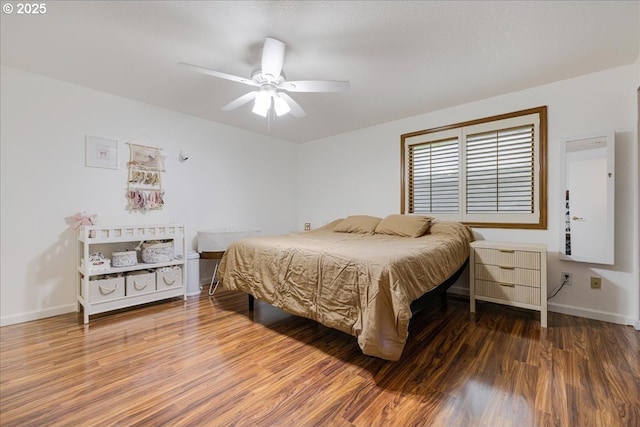 bedroom featuring ceiling fan, baseboards, and wood finished floors