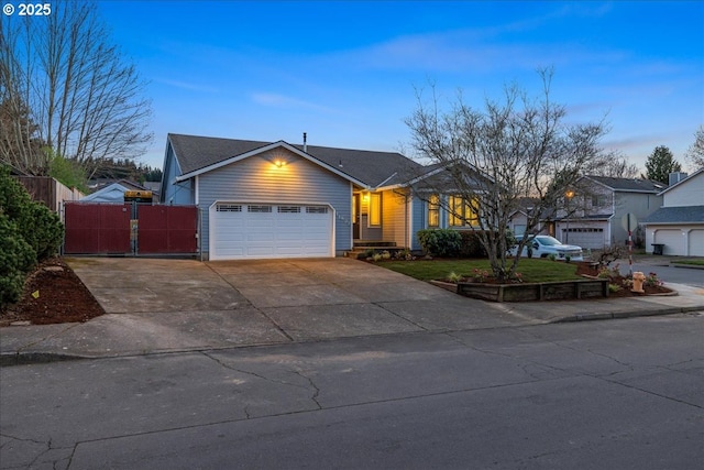 single story home with a garage, concrete driveway, fence, and a gate