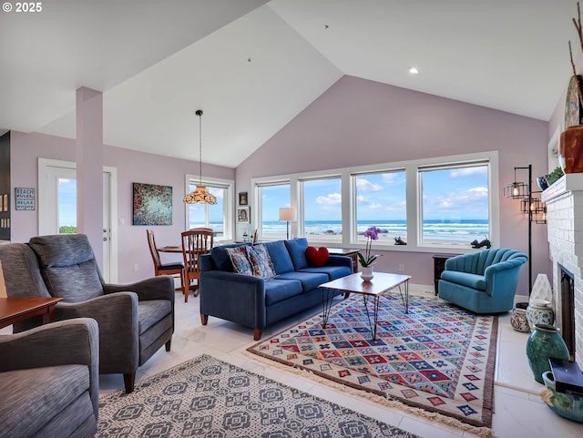3764 Pacific Ave, Cannon Beach, OR 97110 - living area with a fireplace, high vaulted ceiling, and light tile patterned floors