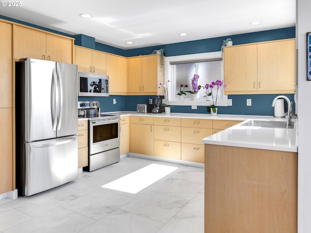 3764 Pacific Ave, Cannon Beach, OR 97110 - kitchen featuring stainless steel appliances, light brown cabinets, light marble finish flooring, light countertops, and recessed lighting