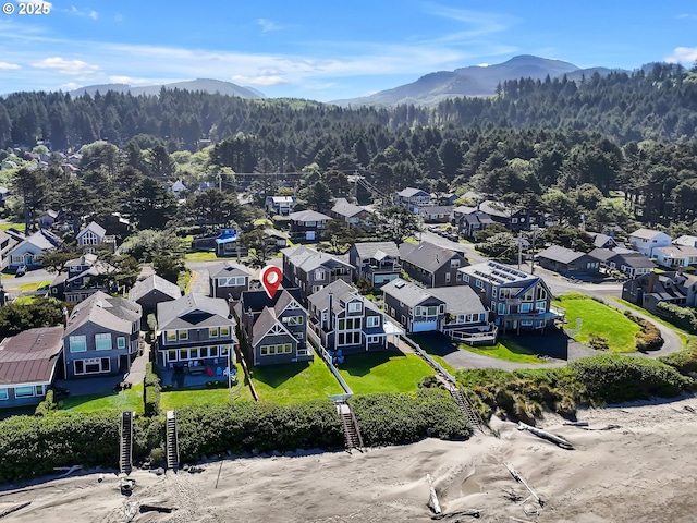 3764 Pacific Ave, Cannon Beach, OR 97110 - aerial view of residential area with a heavily wooded area and a mountain backdrop