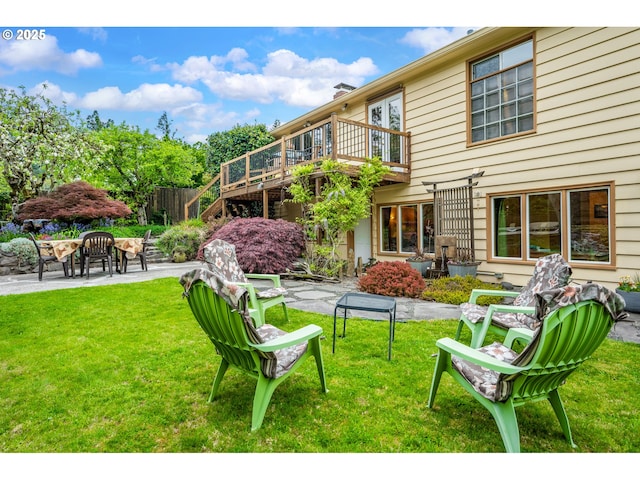 view of yard featuring a wooden deck, stairs, and a patio area