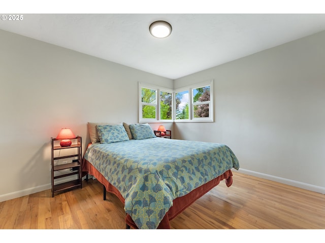 bedroom with baseboards and light wood-style flooring