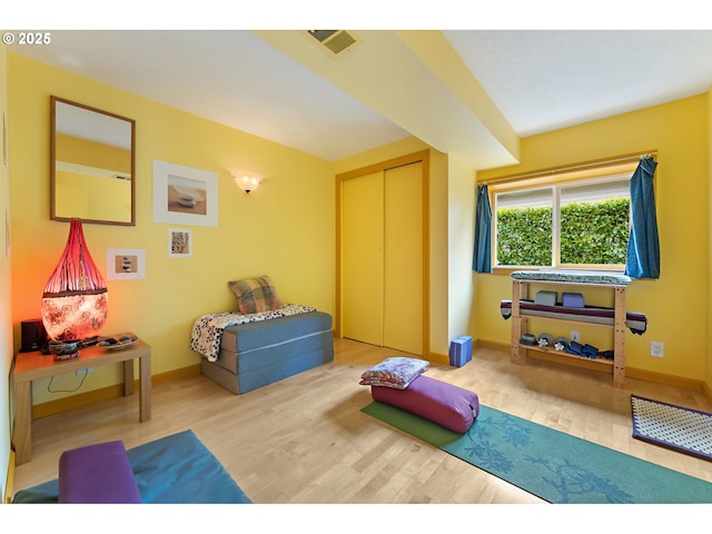 interior space with baseboards, visible vents, and wood finished floors