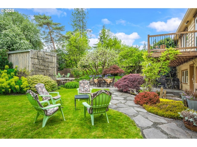 view of yard with a patio area, a deck, and outdoor dining space