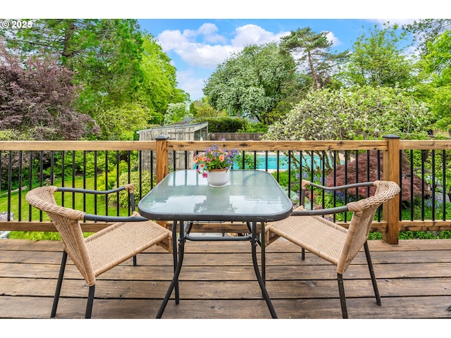 wooden terrace featuring outdoor dining area