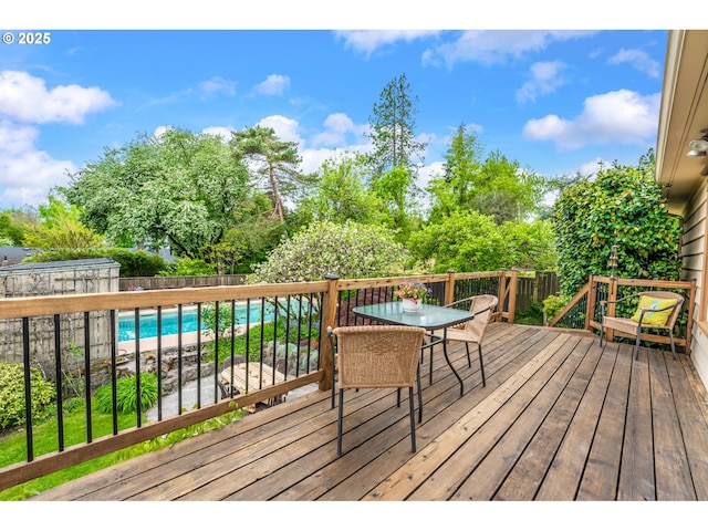 wooden deck featuring outdoor dining area and a fenced backyard