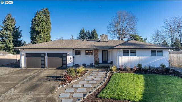 ranch-style house with a garage and a front lawn