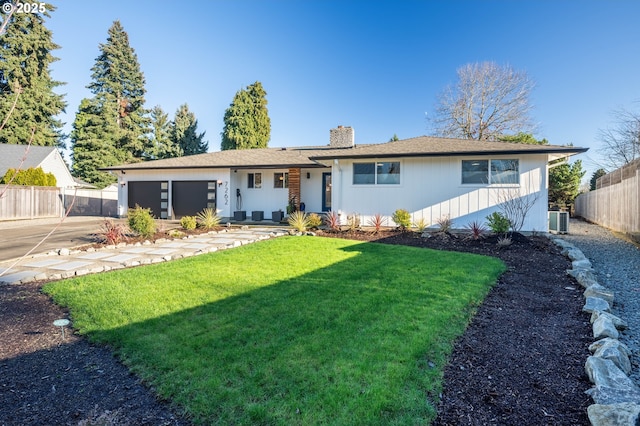 ranch-style home featuring an attached garage, a chimney, fence, and a front yard