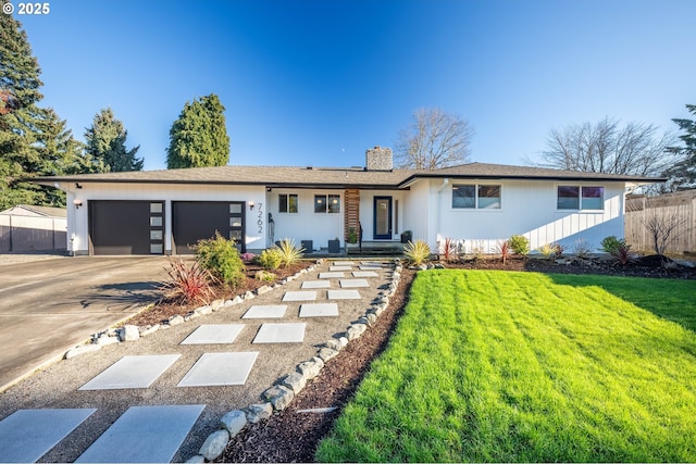 single story home featuring a front yard and a garage