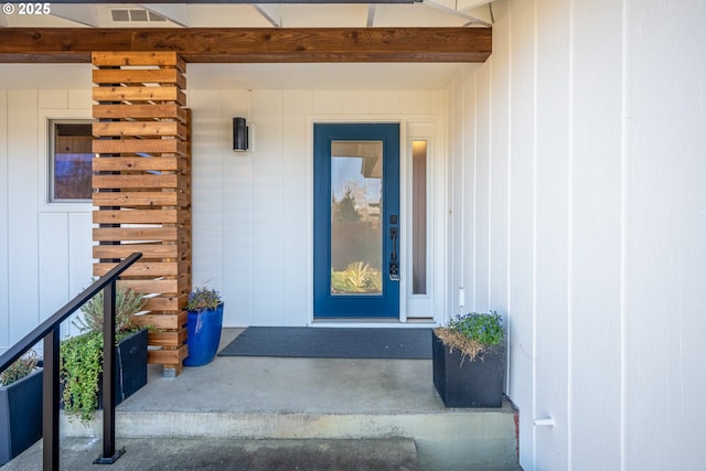 entrance to property featuring visible vents and board and batten siding