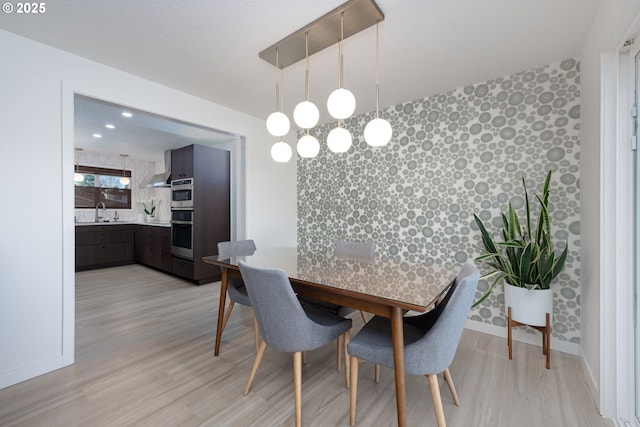 dining room featuring light hardwood / wood-style flooring and sink