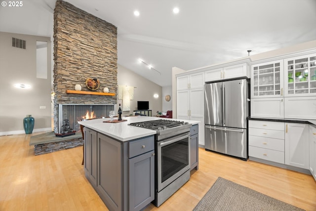 800 Rosemont Rd, West Linn, OR 97068 - kitchen with stainless steel appliances, gray cabinets, a fireplace, light wood-style floors, and white cabinets