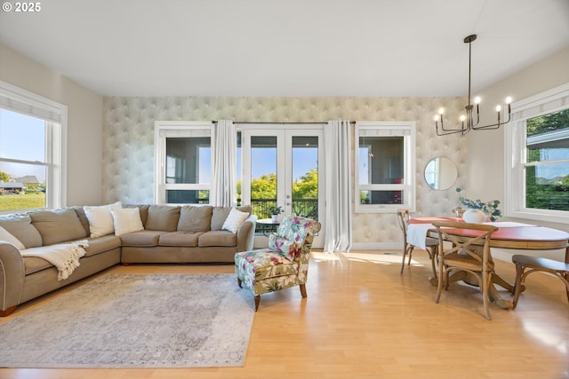 800 Rosemont Rd, West Linn, OR 97068 - living area featuring an accent wall, a chandelier, wood finished floors, and french doors