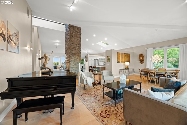 800 Rosemont Rd, West Linn, OR 97068 - living area featuring vaulted ceiling, light wood-style floors, baseboards, rail lighting, and decorative columns