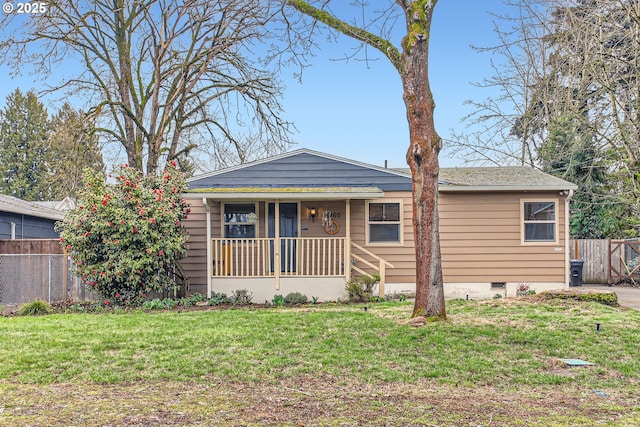 view of front of home featuring a front lawn, fence, covered porch, and crawl space