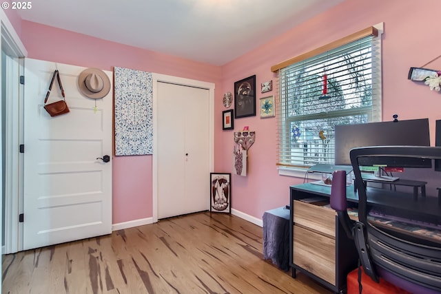 office space featuring baseboards and wood finished floors