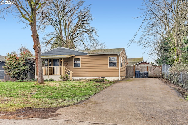 bungalow-style home featuring a front yard and fence