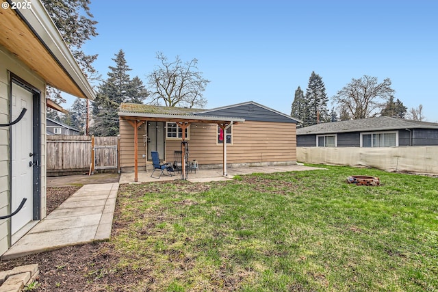 back of property with a lawn, a fenced backyard, and a patio area