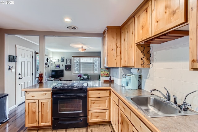 kitchen with visible vents, light brown cabinets, black electric range oven, a sink, and a peninsula