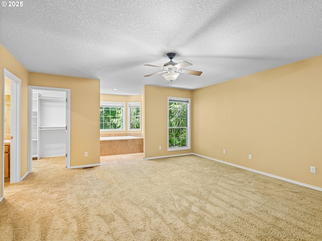 14300 Sherbrook Pl, Lake Oswego, OR 97035 - empty room with ceiling fan, light colored carpet, a textured ceiling, and baseboards