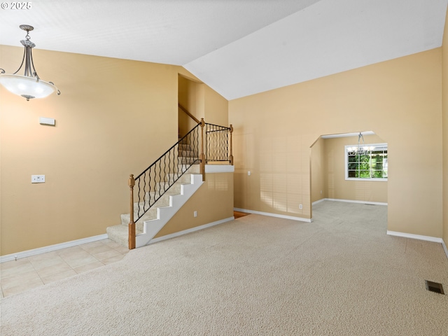 14300 Sherbrook Pl, Lake Oswego, OR 97035 - unfurnished living room with baseboards, stairs, lofted ceiling, arched walkways, and carpet floors