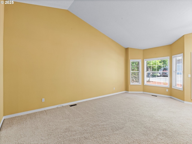 14300 Sherbrook Pl, Lake Oswego, OR 97035 - empty room with light carpet, baseboards, and vaulted ceiling