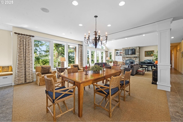 33525 Beerman Creek Ln, Seaside, OR 97138 - dining space with ornate columns, a stone fireplace, recessed lighting, a chandelier, and lofted ceiling