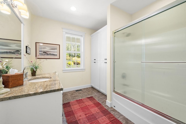 33525 Beerman Creek Ln, Seaside, OR 97138 - full bath featuring baseboards, vanity, combined bath / shower with glass door, tile patterned floors, and recessed lighting