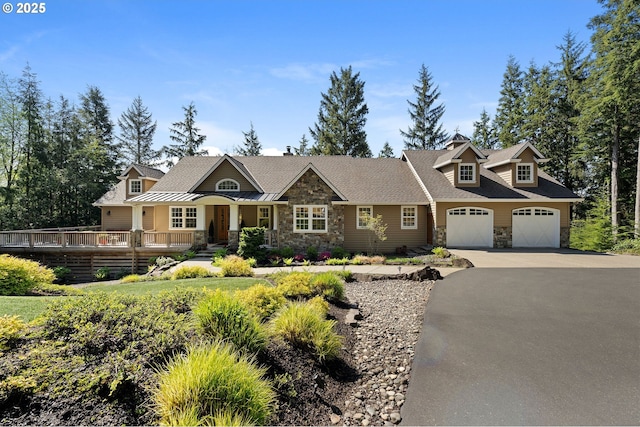 33525 Beerman Creek Ln, Seaside, OR 97138 - view of front of property with stone siding, asphalt driveway, a standing seam roof, and a deck
