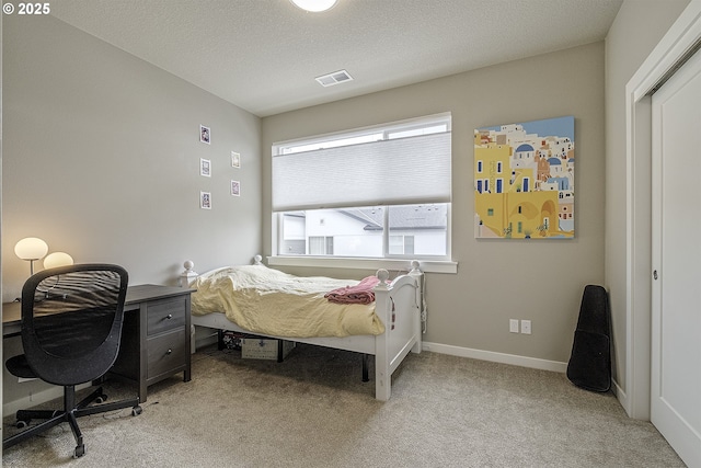 bedroom featuring baseboards, carpet flooring, and visible vents