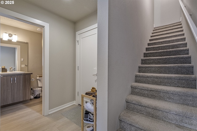 stairs featuring baseboards and wood finished floors